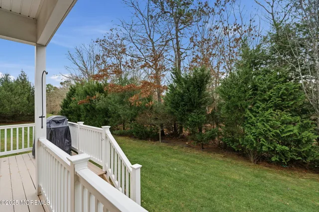 a view of house with backyard and trees