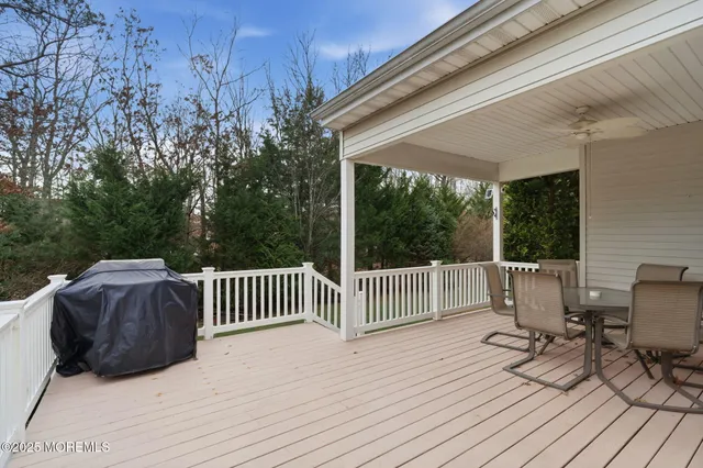 a view of balcony with wooden floor and outdoor seating