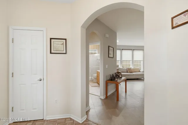a view of a livingroom with wooden floor and a flat screen tv