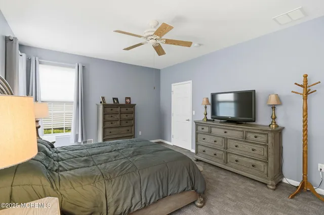 a bedroom with a bed and flat screen tv