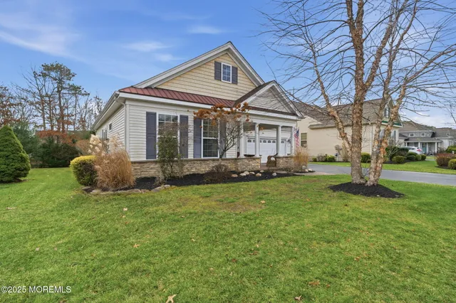 a front view of a house with a garden