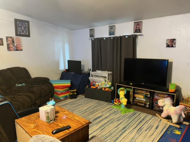 900 East Rankin Road, Unit 5 Tulare, CA 93274 - Photo 9 of 26 a living room with furniture and a flat screen tv