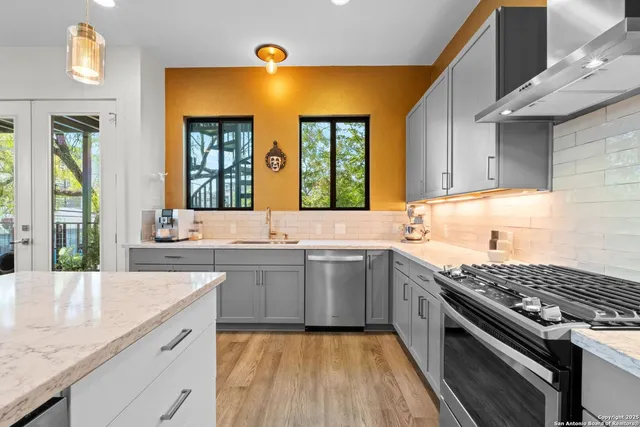 a kitchen with a sink stove and cabinets