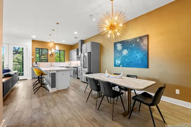 a room with a table chairs and a dining table with wooden floor