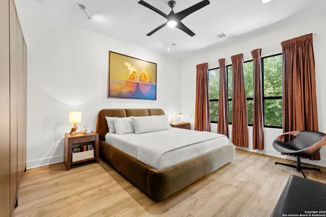 a bedroom with a bed a couch and a window