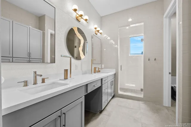 a bathroom with a double vanity sink mirror and