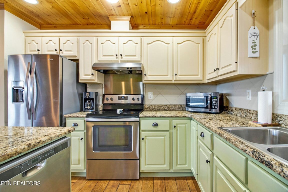1375 Back Bone Road Sparta, TN 38583 - Photo 15 of 52 a kitchen with stainless steel appliances granite countertop a sink stove and refrigerator
