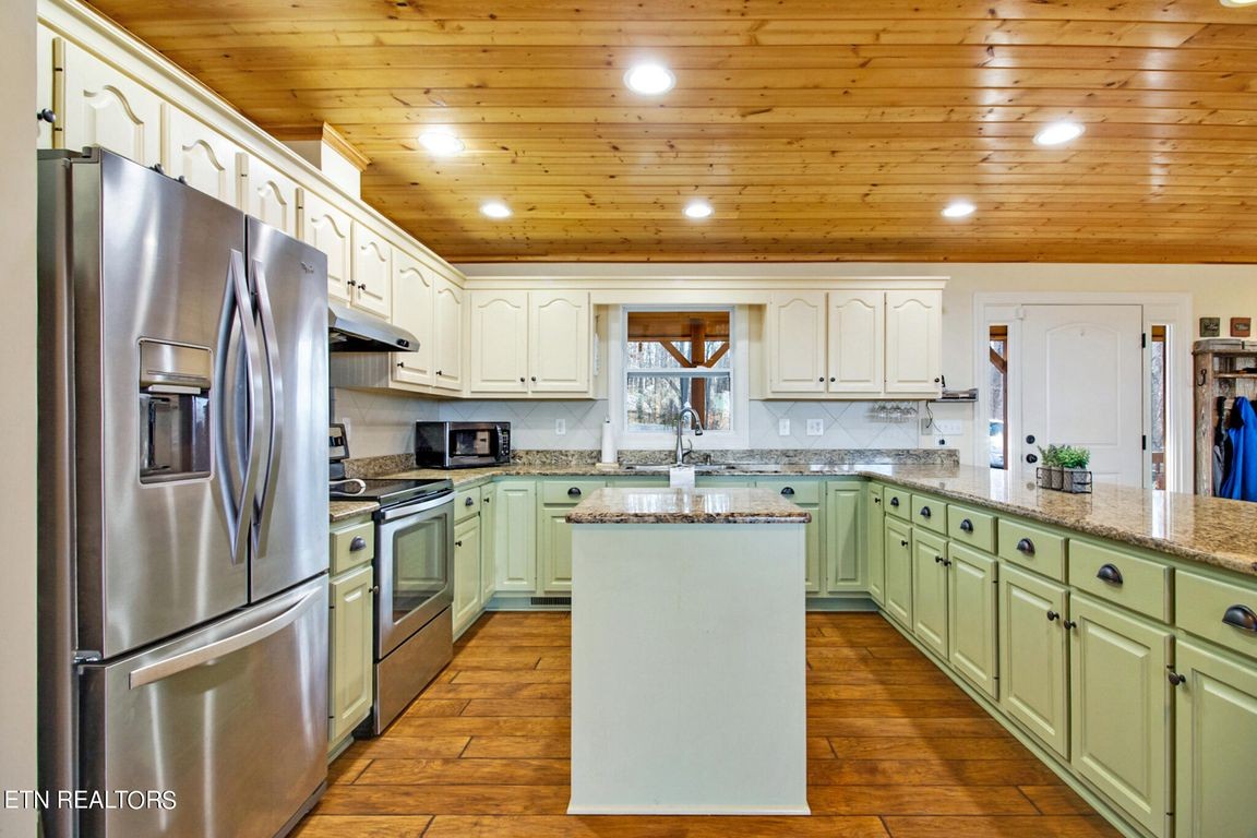 1375 Back Bone Road Sparta, TN 38583 - Photo 21 of 52 a kitchen with stainless steel appliances granite countertop a sink refrigerator and cabinets