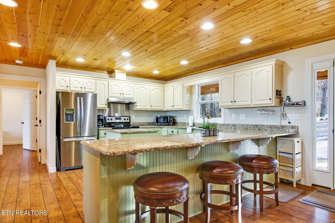 1375 Back Bone Road Sparta, TN 38583 - Photo 22 of 52 a kitchen with stainless steel appliances granite countertop a stove refrigerator sink and cabinets
