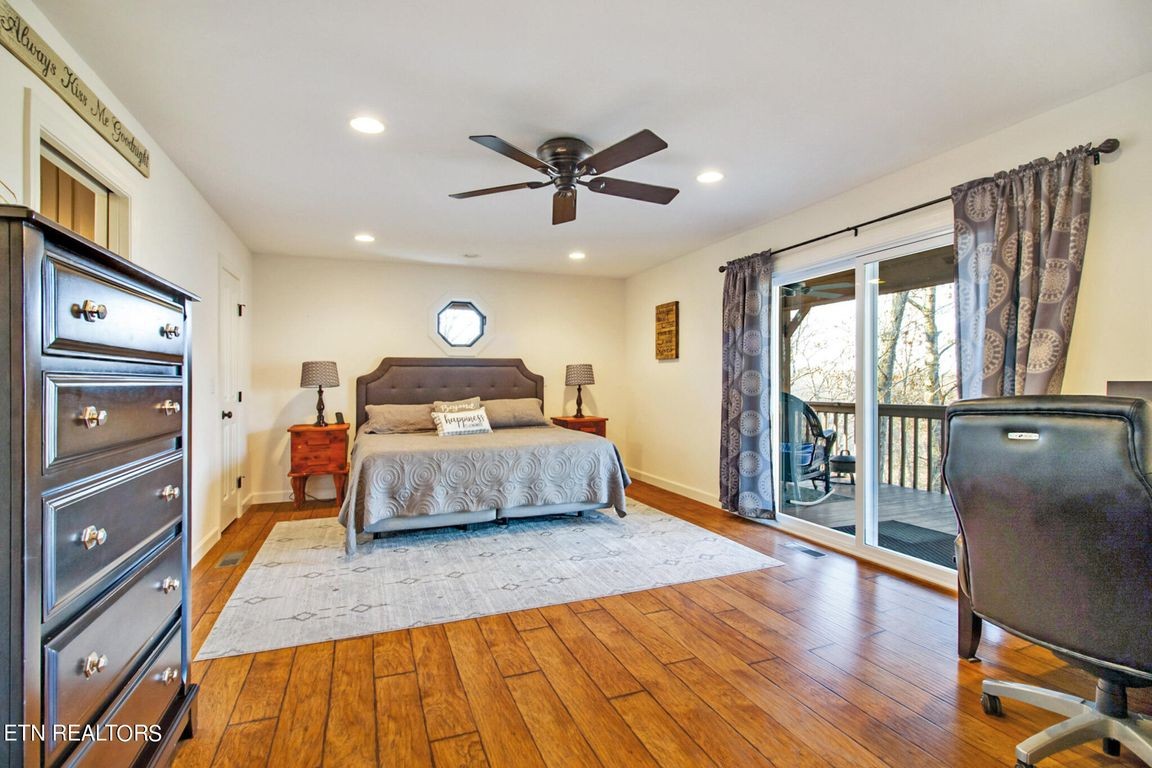 1375 Back Bone Road Sparta, TN 38583 - Photo 25 of 52 a bedroom with a large bed and a chandelier
