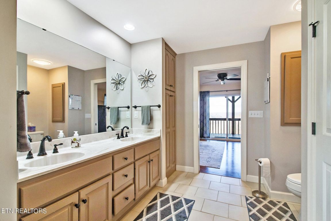 1375 Back Bone Road Sparta, TN 38583 - Photo 29 of 52 a spacious bathroom with a double vanity sink a mirror and a bathtub