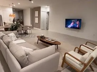 a bedroom with a bed two couch and a window