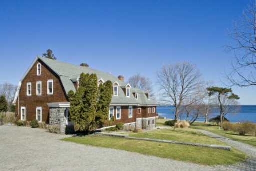 Undisclosed Address Darien, CT 06820 - Photo 2 of 8 a front view of a house with a yard