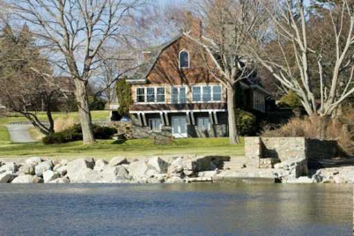 Undisclosed Address Darien, CT 06820 - Photo 7 of 8 a front view of a house with a yard table and chairs