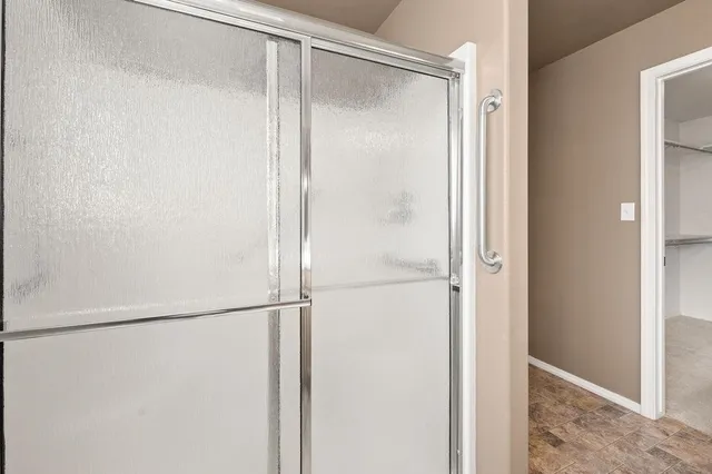 a bathroom with a glass shower door