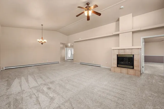 a view of empty room with fireplace and fan