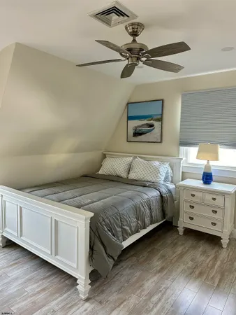 a bedroom with a bed and a ceiling fan
