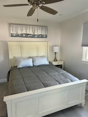 a bedroom with a bed and chandelier