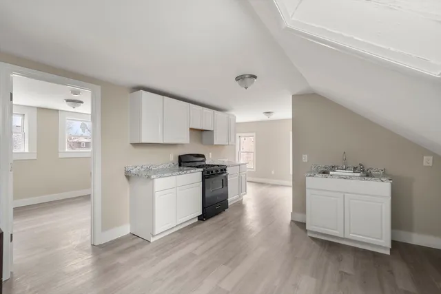 a kitchen with a refrigerator stove and wooden cabinets
