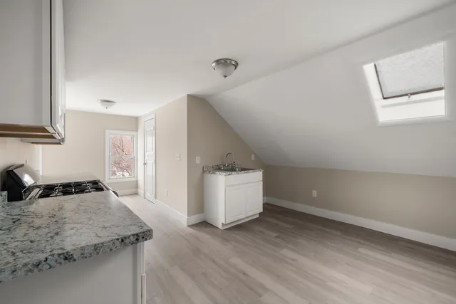 a kitchen that has a sink and a stove in it