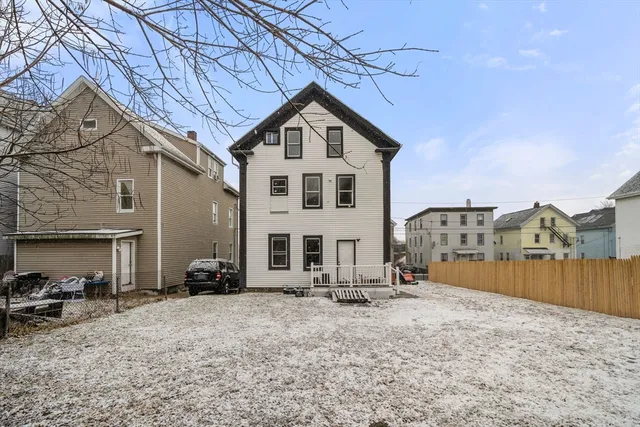 a view of a house with wooden fence