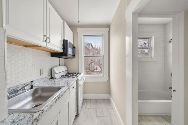 a kitchen with a sink stove and refrigerator