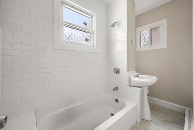 a bathroom with a bathtub and a toilet