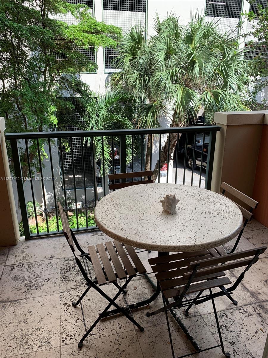 a view of a chairs and table in patio
