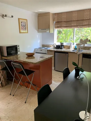 a dining room with a desk and a window