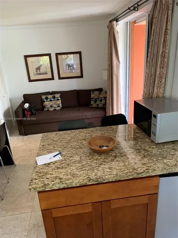 a living room with granite countertop furniture and painting on the wall