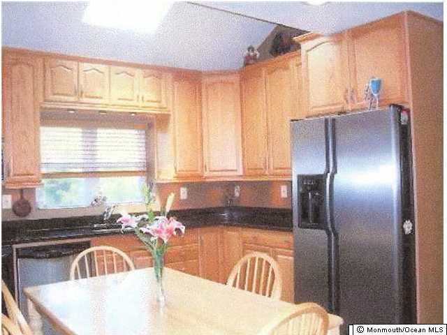 361 Jackson Mills Road Freehold, NJ 07728 - Photo 3 of 3 a kitchen with granite countertop a refrigerator and a sink