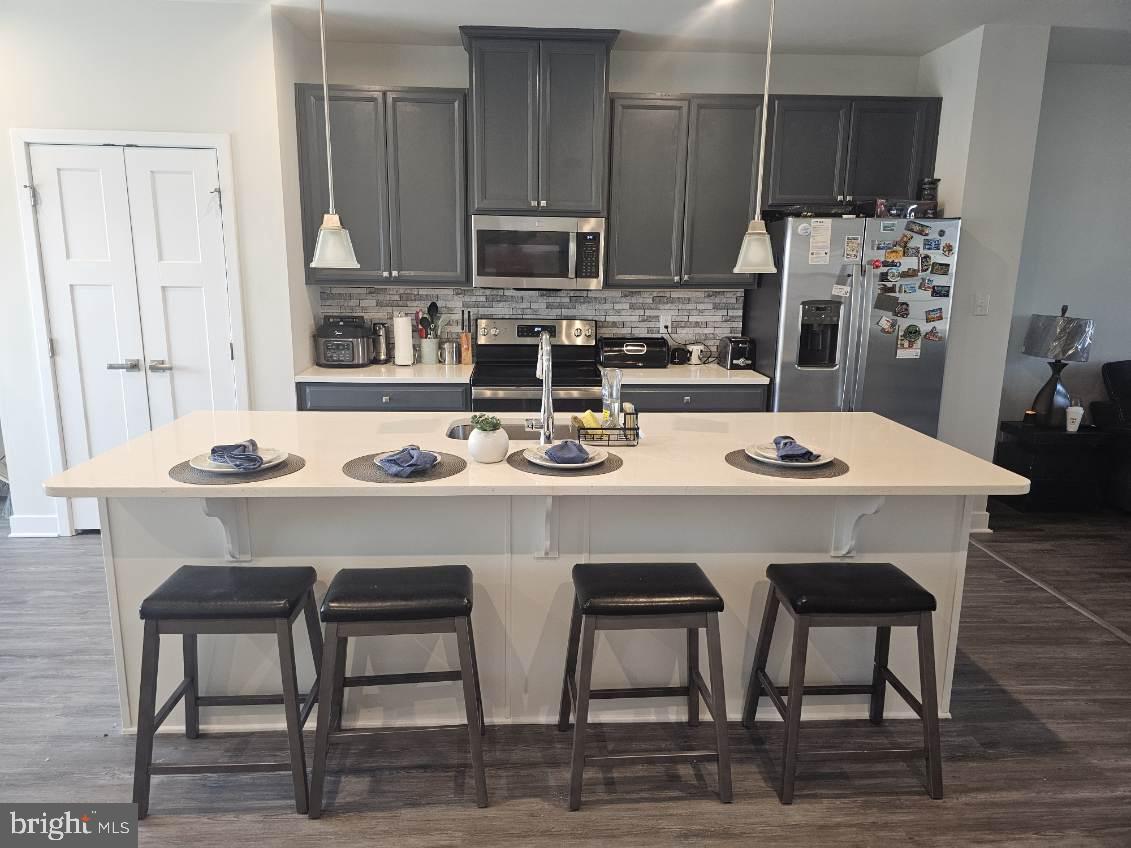 108 Freedom Way Sicklerville, NJ 08081 - Photo 3 of 9 a kitchen with stainless steel appliances a sink a table and chairs