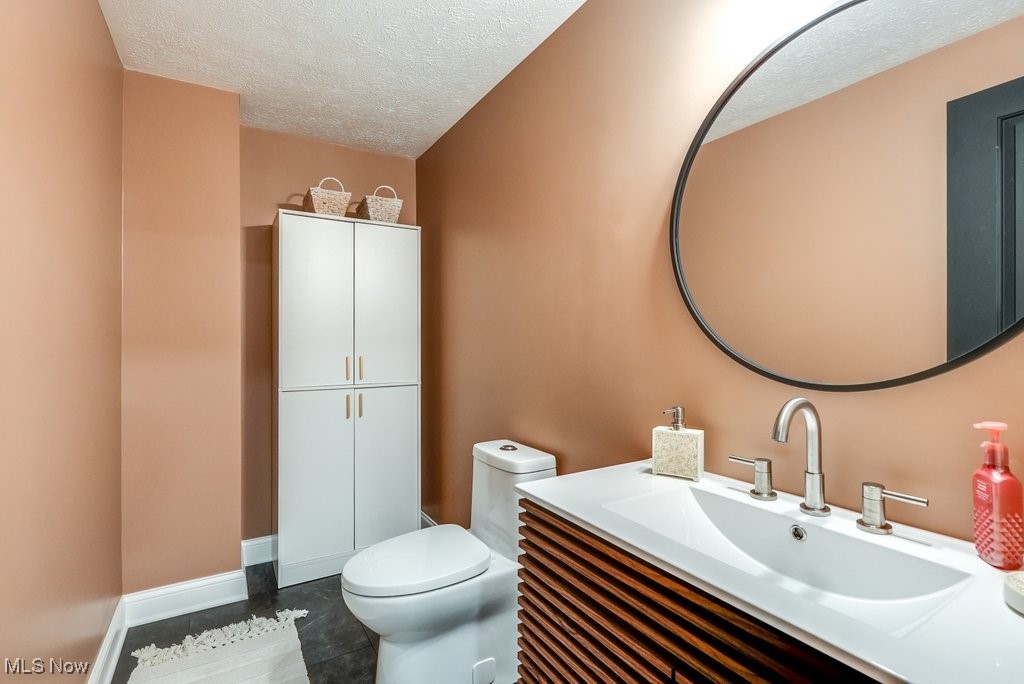 1598 Graham Road Silver Lake, OH 44224 - Photo 38 of 46 Bathroom featuring a textured ceiling, vanity, and toilet