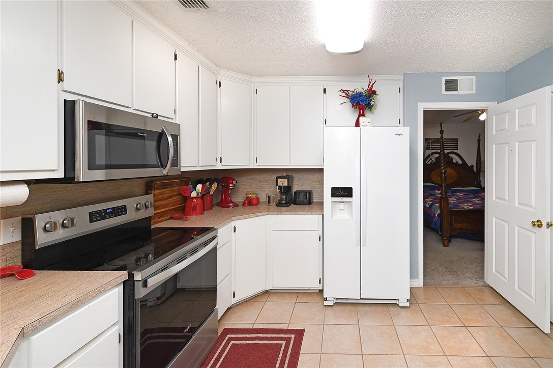 2101 Capeheart Street Ingleside, TX 78362 - Photo 12 of 39 a kitchen with a refrigerator and a stove top oven