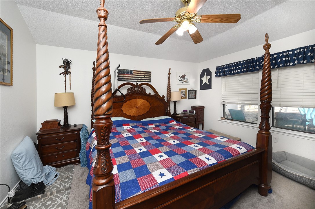 2101 Capeheart Street Ingleside, TX 78362 - Photo 13 of 39 a bedroom with a bed window and lamp on table