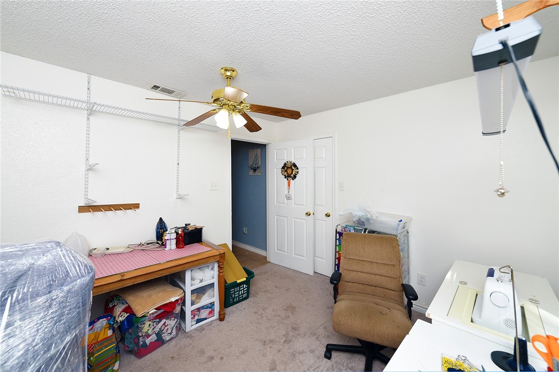 2101 Capeheart Street Ingleside, TX 78362 - Photo 25 of 39 a bedroom with furniture and a chandelier