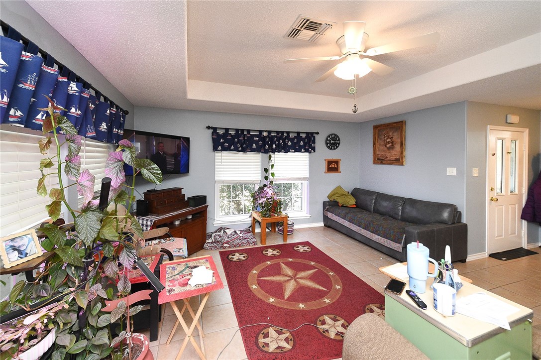 2101 Capeheart Street Ingleside, TX 78362 - Photo 4 of 39 a living room with furniture a chandelier and a rug