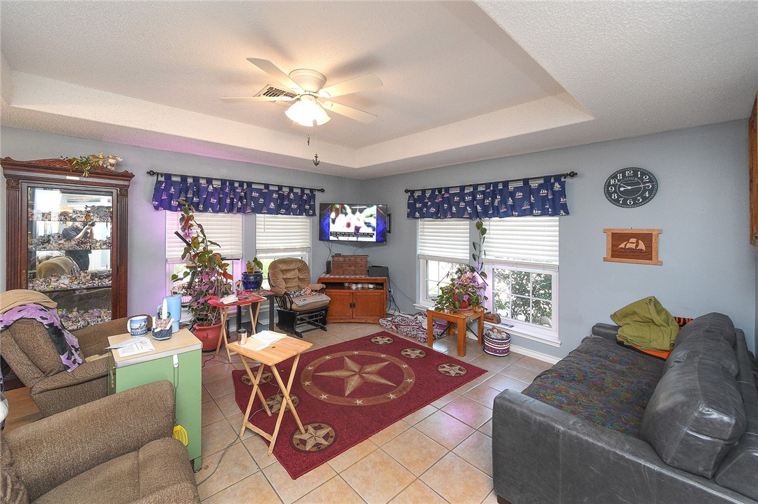 2101 Capeheart Street Ingleside, TX 78362 - Photo 5 of 39 a living room with furniture a chandelier and a large window