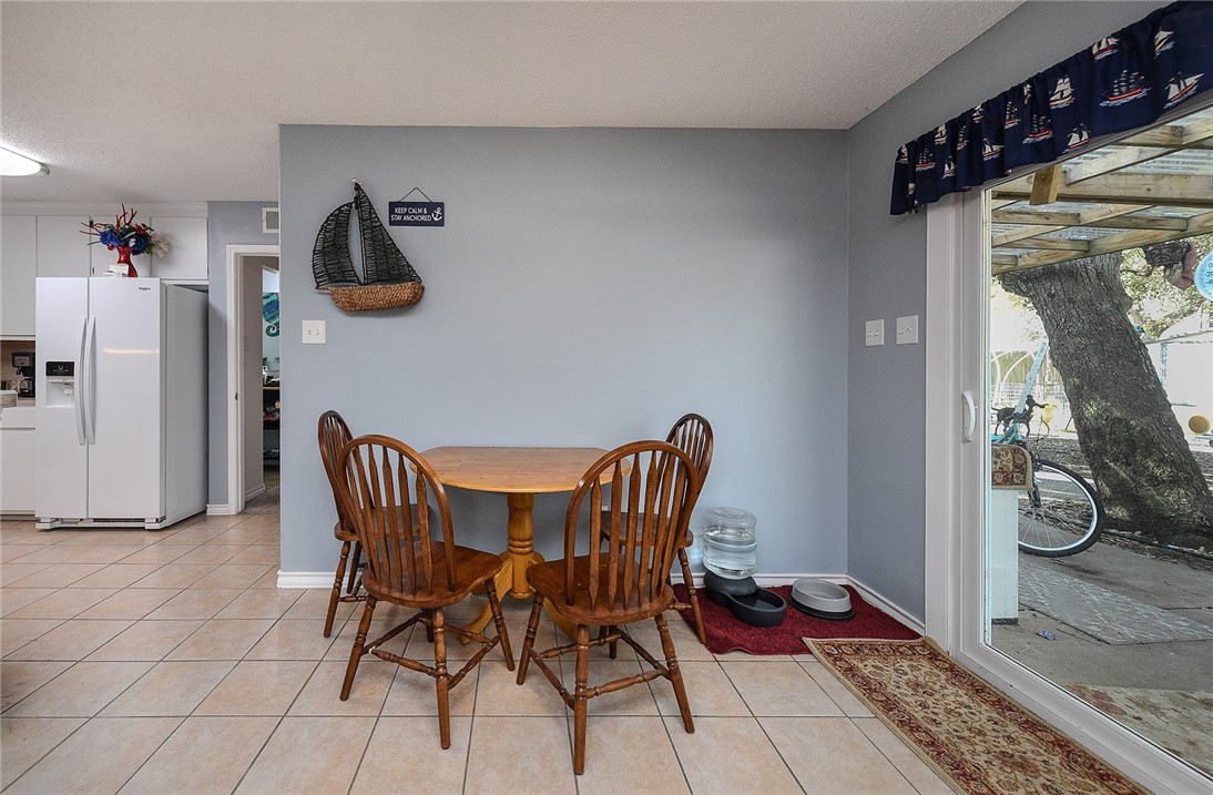 2101 Capeheart Street Ingleside, TX 78362 - Photo 7 of 39 a view of a dining room with furniture and wooden floor