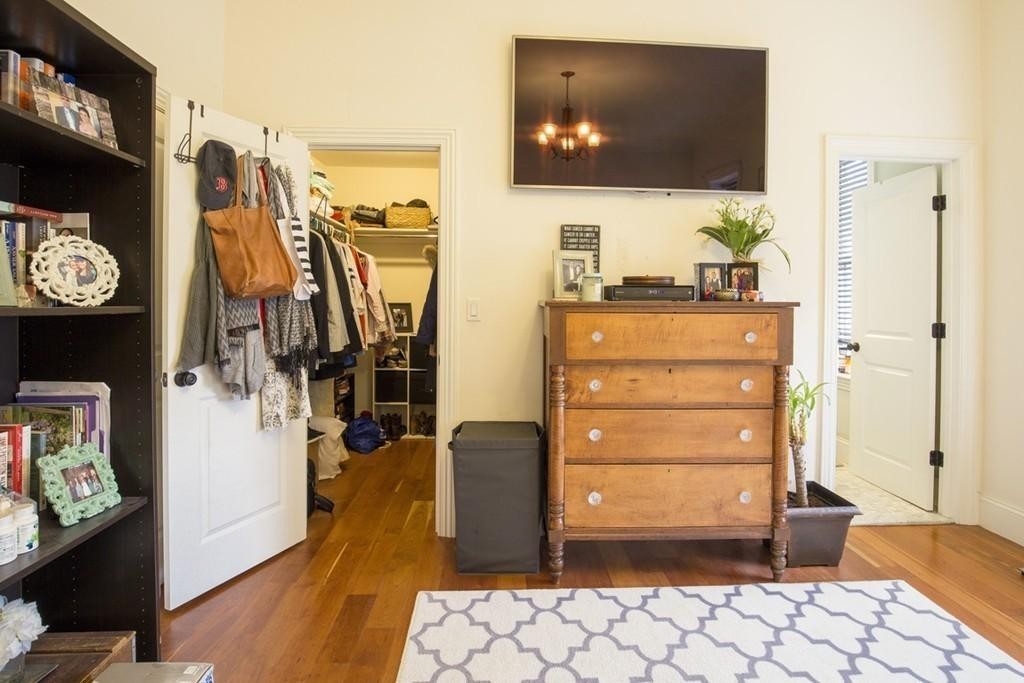 8 Gates Street, Unit 1 Boston, MA 02127 - Photo 11 of 14 a living room with a flat screen tv and a walk in closet