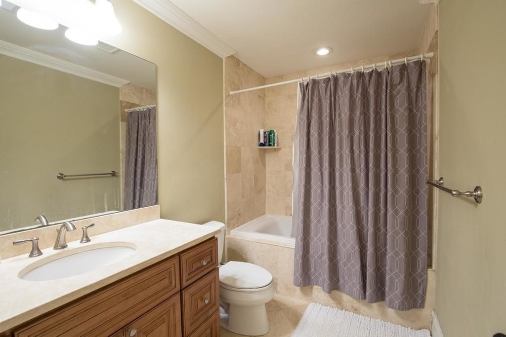 8 Gates Street, Unit 1 Boston, MA 02127 - Photo 13 of 14 a bathroom with a granite countertop sink toilet and shower