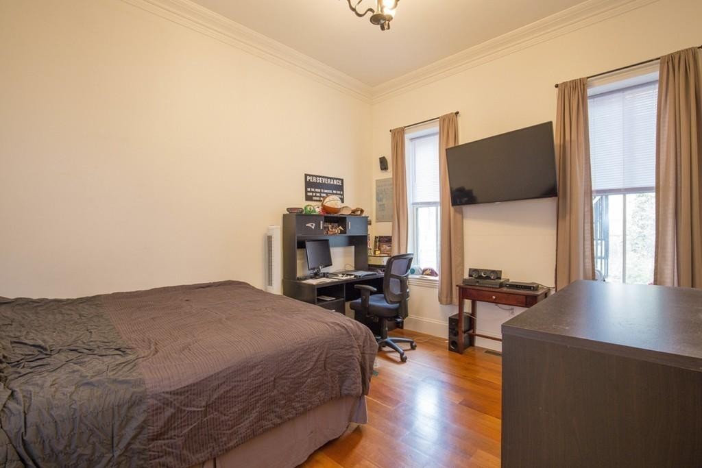 8 Gates Street, Unit 1 Boston, MA 02127 - Photo 14 of 14 a bedroom with a bed and wooden floor