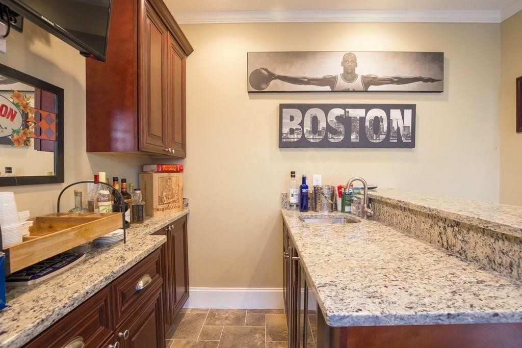 8 Gates Street, Unit 1 Boston, MA 02127 - Photo 5 of 14 a kitchen with stainless steel appliances granite countertop a sink stove and cabinets