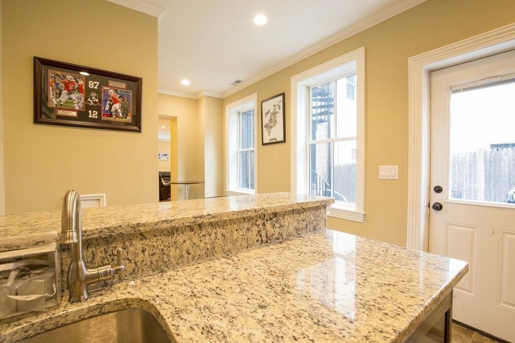 8 Gates Street, Unit 1 Boston, MA 02127 - Photo 6 of 14 a view of a kitchen with kitchen island and windows
