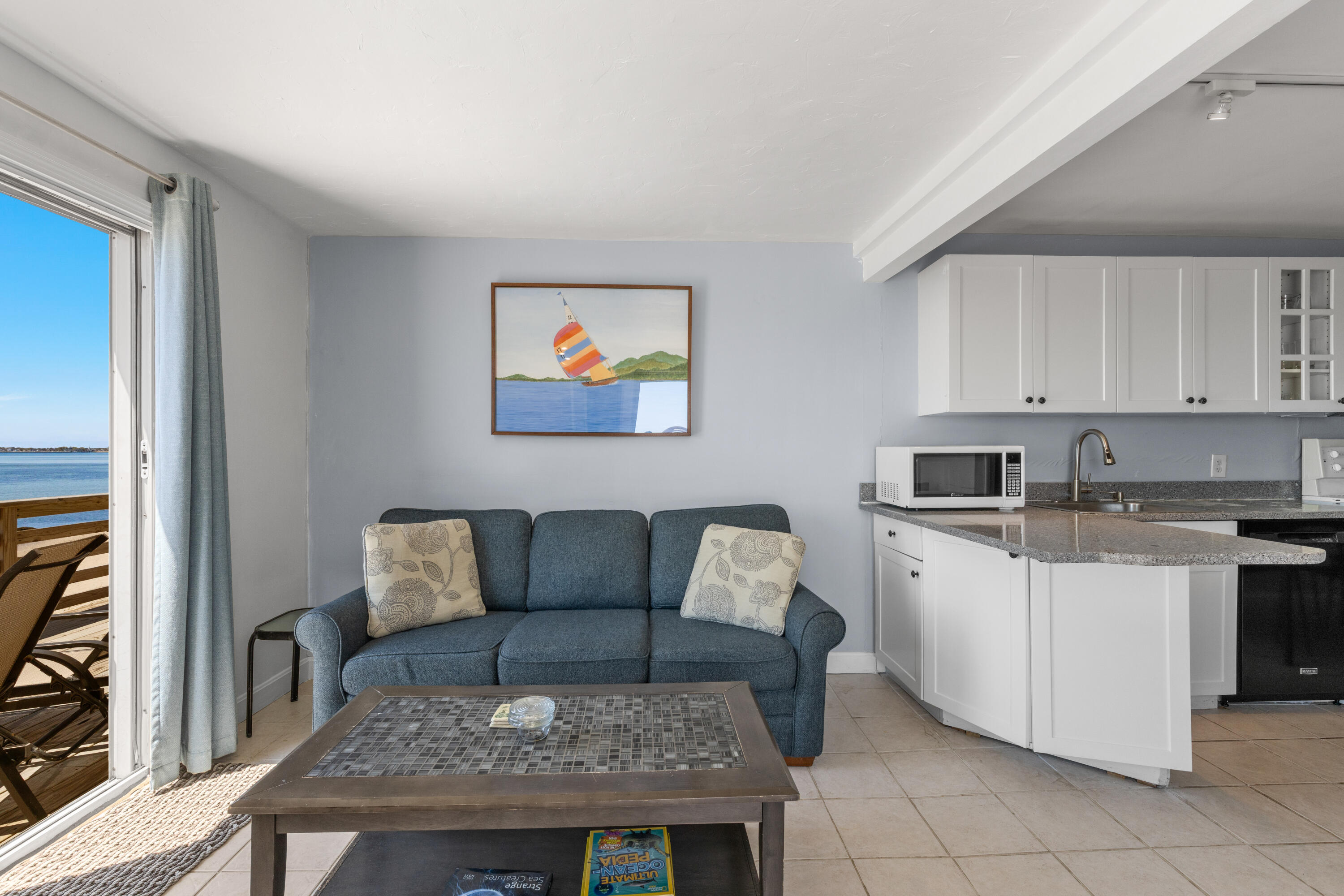 538 Shore Road, Unit 3 Truro, MA 02666 - Photo 5 of 27 a living room with stainless steel appliances granite countertop furniture a rug a stove and a refrigerator