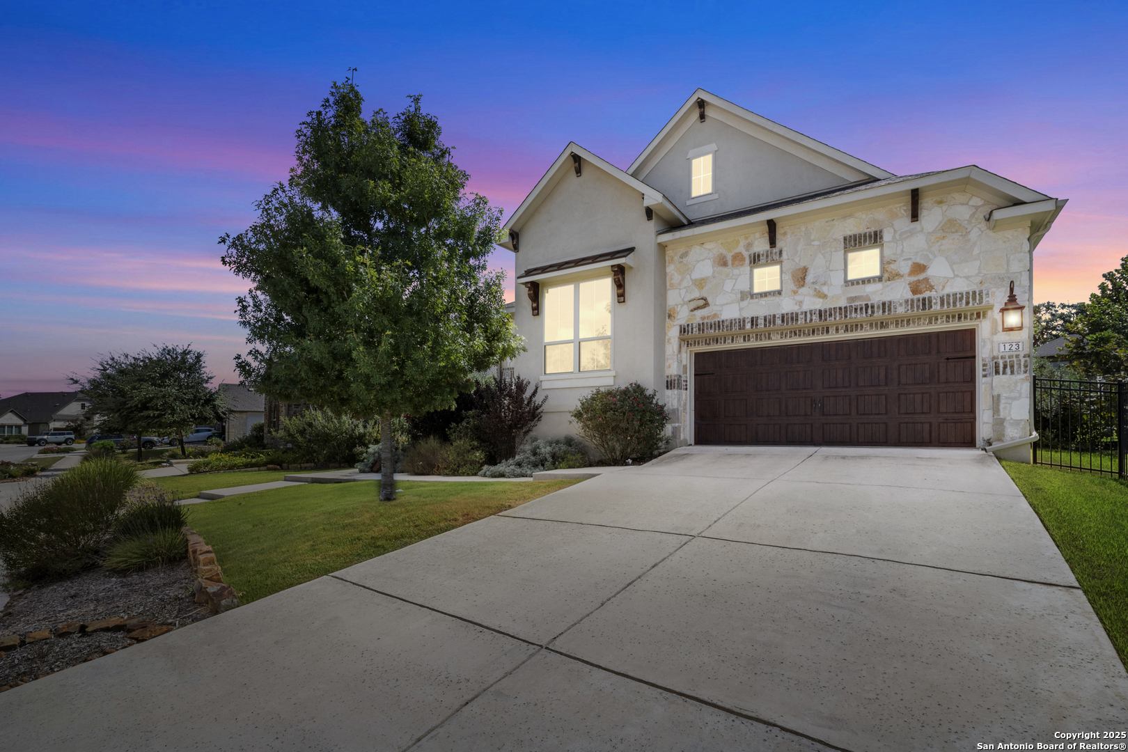 a front view of a house with a garden and yard