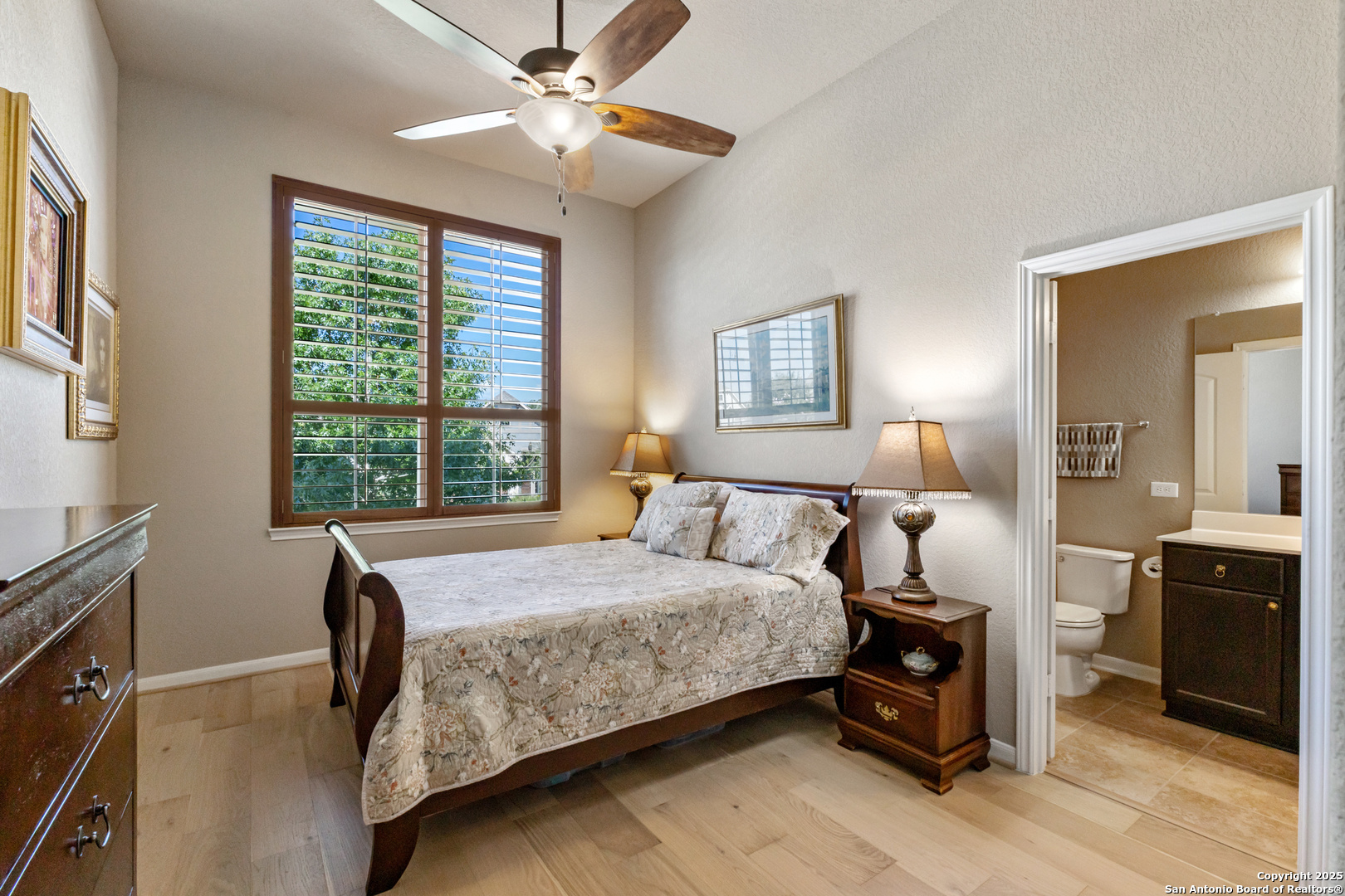 123 Gaucho Boerne, TX 78006 - Photo 15 of 26 a bedroom with a bed and a chandelier