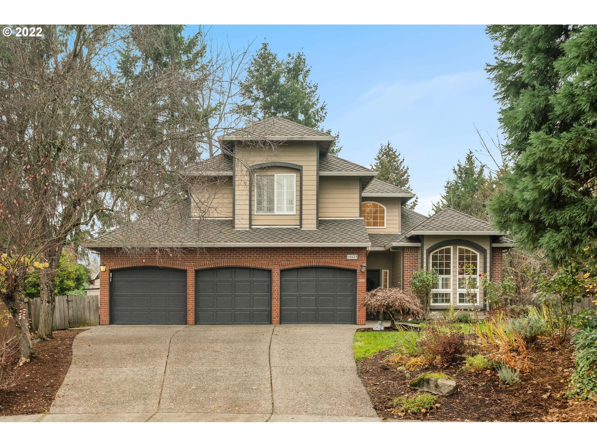 16625 Southwest Springwater Court Beaverton, OR 97006 - Photo 1 of 32 a front view of a house with a garden