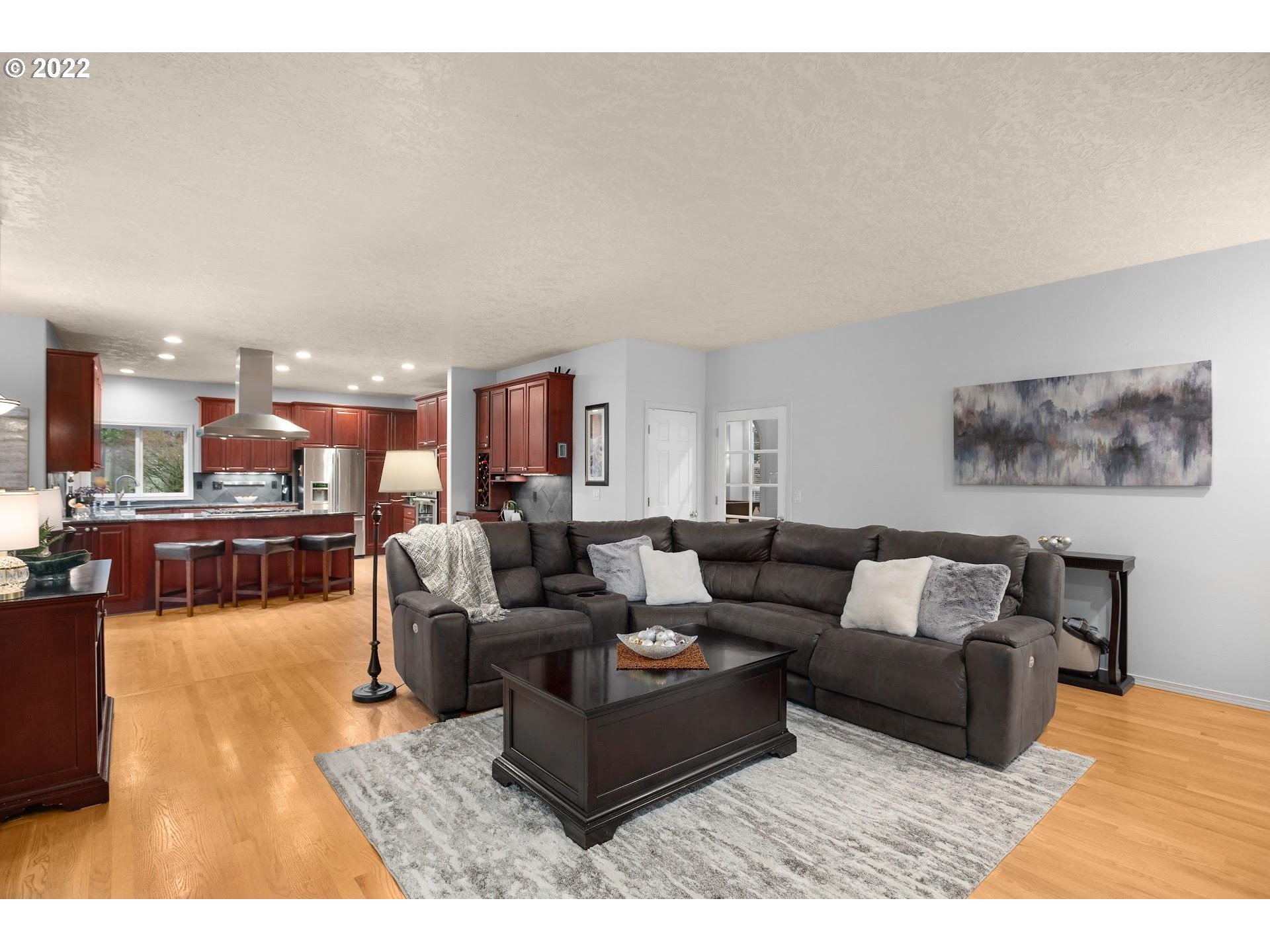 16625 Southwest Springwater Court Beaverton, OR 97006 - Photo 15 of 32 a living room with furniture and a view of kitchen