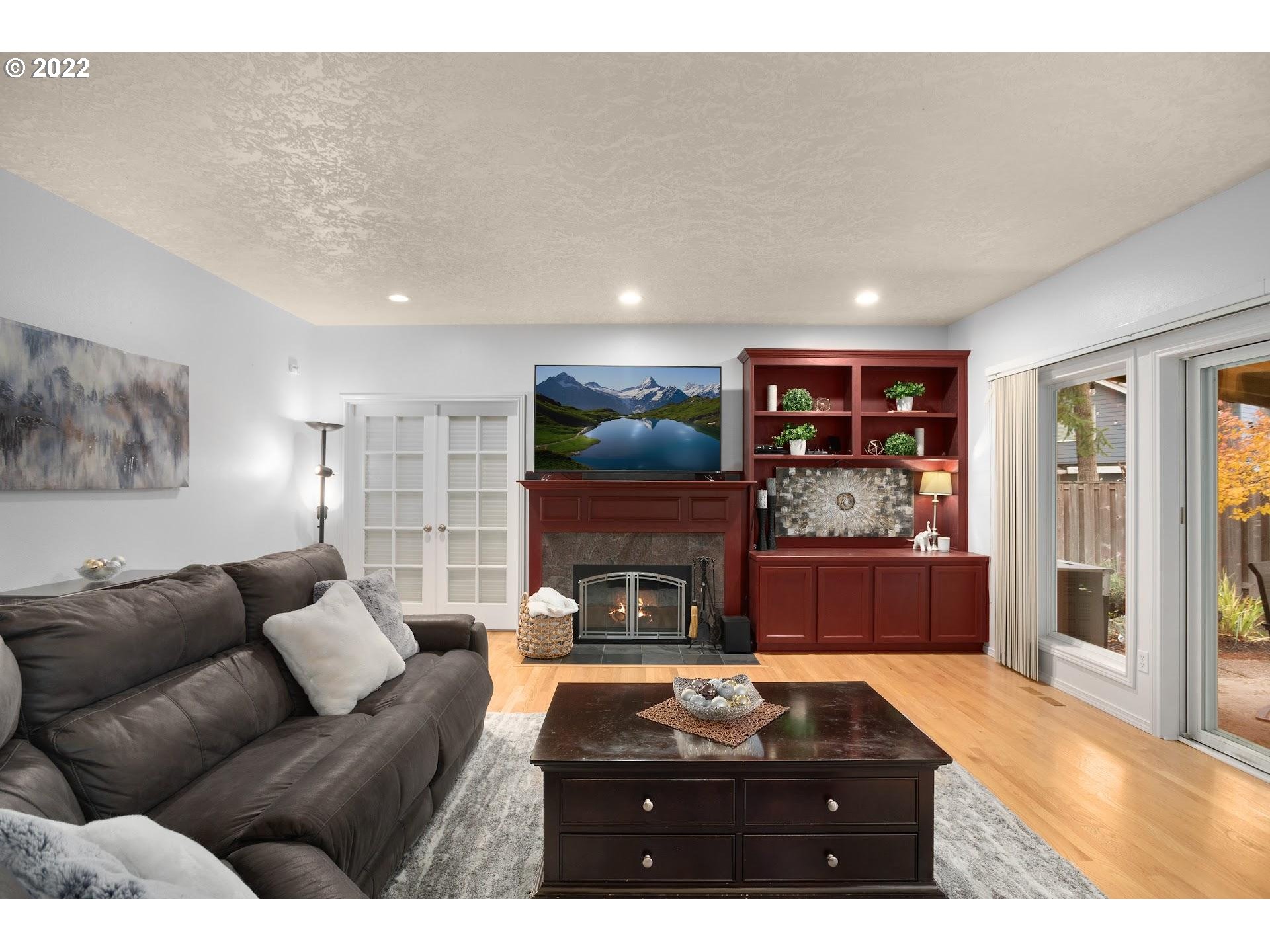 16625 Southwest Springwater Court Beaverton, OR 97006 - Photo 16 of 32 a living room with furniture and a flat screen tv